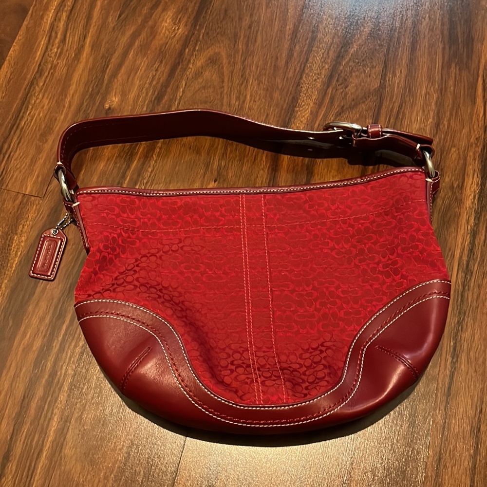 Coach red shoulder bag with monogram print.